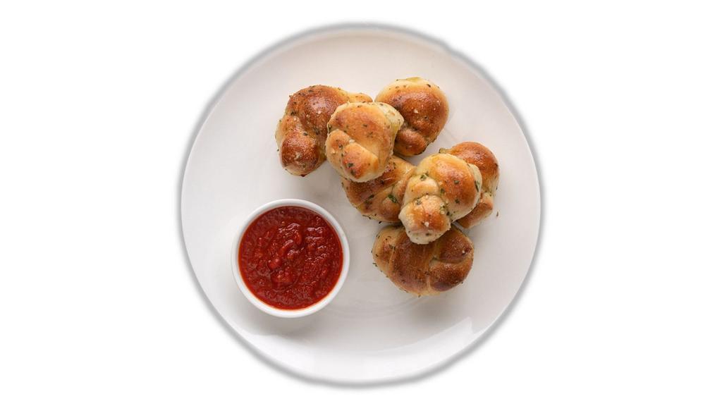 Garlic Knots · Freshly baked with savory blend of fresh garlic, virgin olive oil, oregano & parsley. Finished with parmesan.