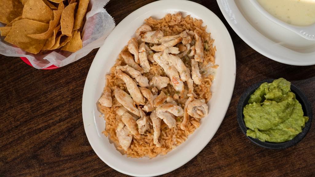Pollo Con Arroz · A bed of rice topped with strips of grilled, chicken and white queso.