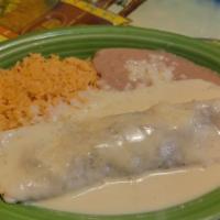 Lunch Burrito Al Carbon · Grilled strips of chicken or steak topped with white queso. Served with rice and beans.