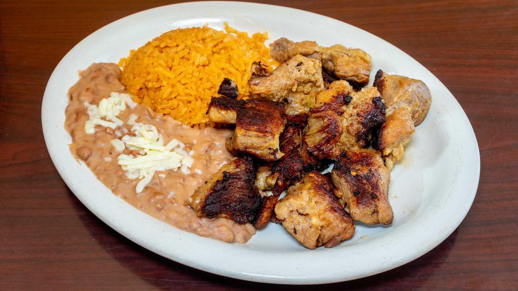 Lunch Carnitas · Deep-fried, seasoned pork chunks served with rice beans, tomatillo sauce, and tortillas.