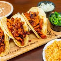 Tacos De Pastor · Three tacos marinated pork, served with rice, beans, lettuce, sour cream and pico de gallo.