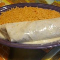 Burrito Al Carbon · Grilled strips of chicken or steak rolled in a flour tortilla with white queso on top. Serve...