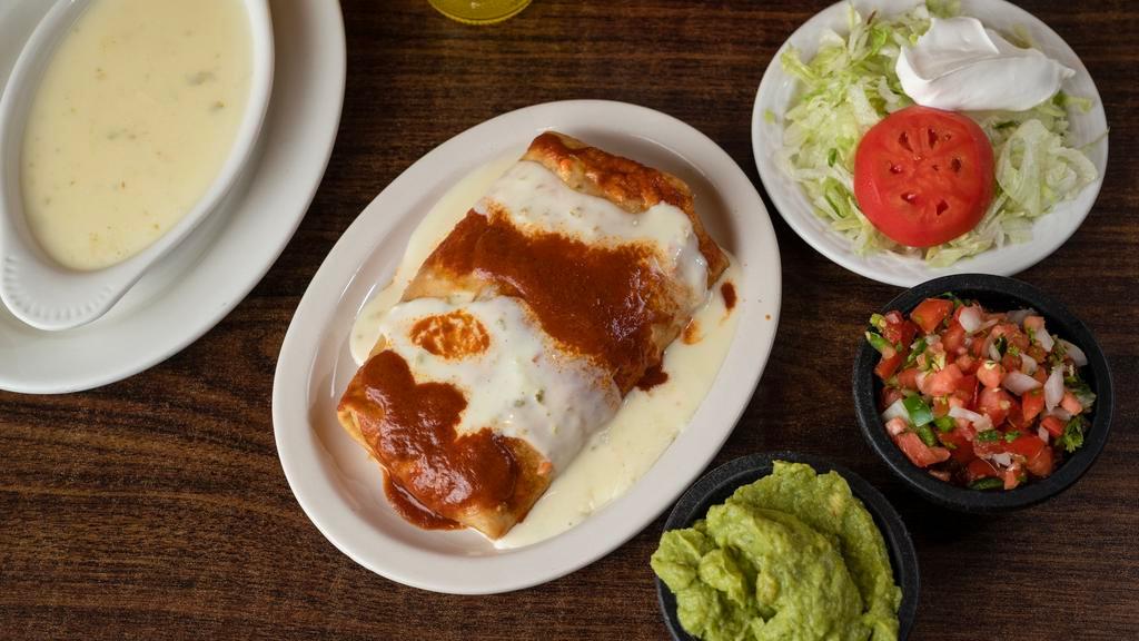 Macho Burrito · Extra big, deep fried with shredded beef or chicken, beans, lettuce, and sour cream, topped with white queso and enchilada sauce.
