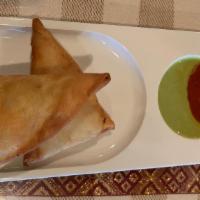 Two Abyssinia Sambusa · two Pastry filled with vegetables and your choice of chicken, beef or lentil.