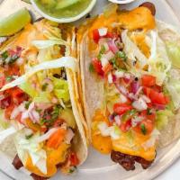 Fish Tacos ( 2 ) · 2 corn tortillas with melted cheese , cod fish fried in our special beer batter topped with ...