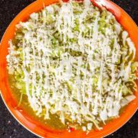 Chilaquiles Verdes · Fried triangles of corn tortillas simmered in a green salsa , and served with cheese , and e...