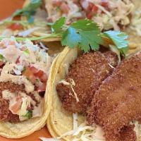 California Fish Tacos · Three tacos with tilapia, chipotle sauce, cabbage, pico de gallo, avocado and served with ri...