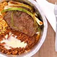 Carne Asada · Grilled steak served with rice, beans, guacamole salad, pico de gallo, scallions and tortill...