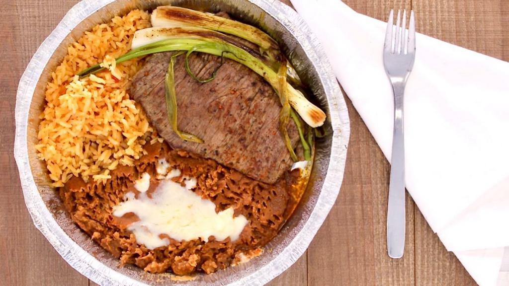 Carne Asada · Grilled steak served with rice, beans, guacamole salad, pico de gallo, scallions and tortillas.
