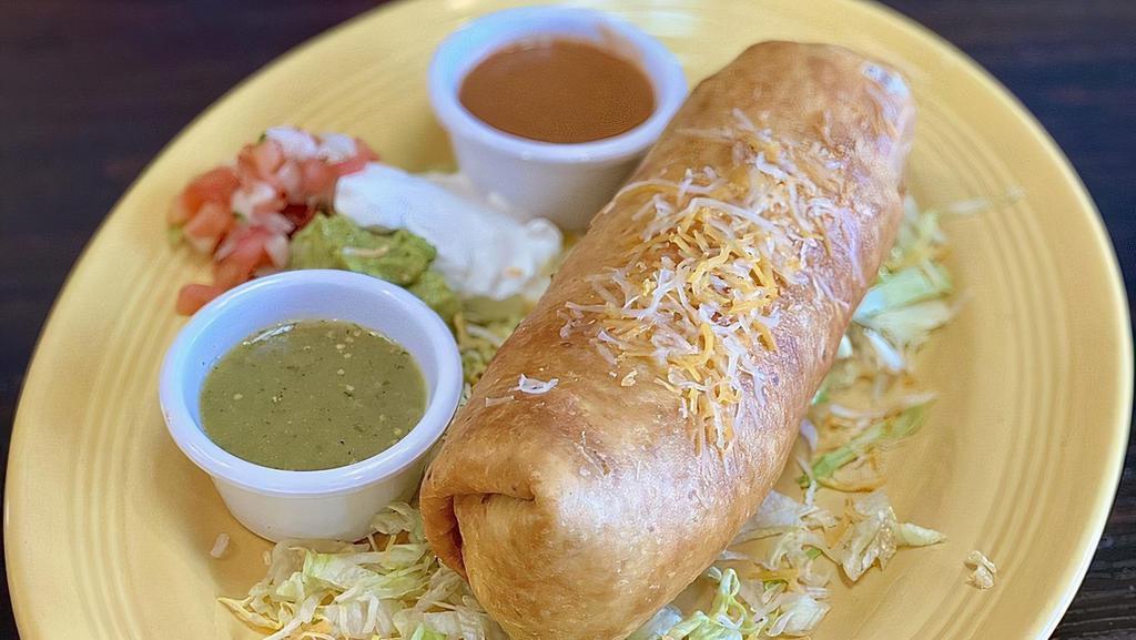 Chimichanga · Soft or fried tortilla filled with beef tips or chicken. topped with cheese dip sour cream salad and served with rice.