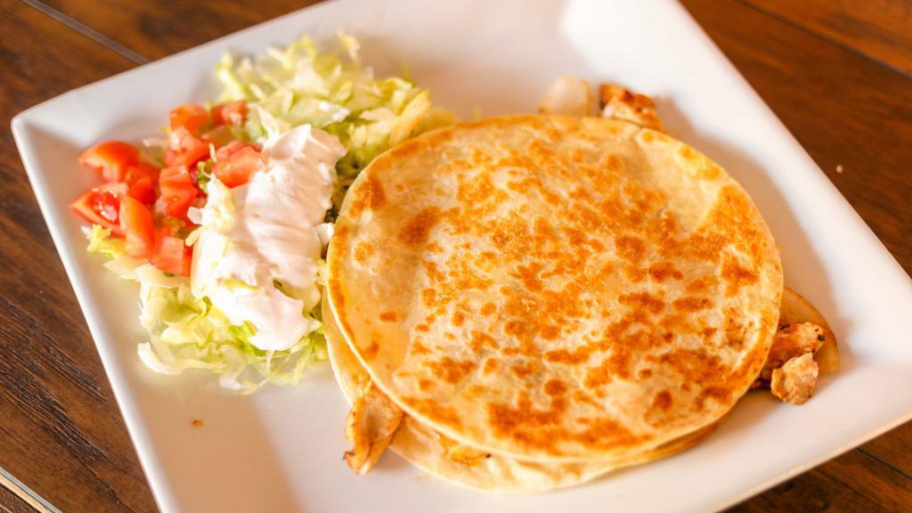 Quesadilla Ranchera · One quesadilla filled with beans, cheese, onions and your choice of grilled chicken or steak.
