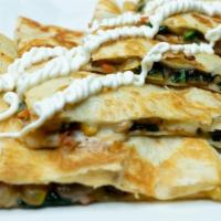 Quesadilla Vegetariana · Flour tortilla filled with a mix of sautéed spinach, green zucchini, yellow squash, mushroom...