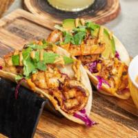 Shrimp Taco · Grilled tacos served with cilantro and onions.