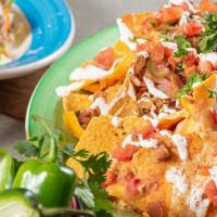 Nachos Supreme · Choice of chicken or ground beef topped with lettuce, cheese, tomatoes, sour cream, guacamol...