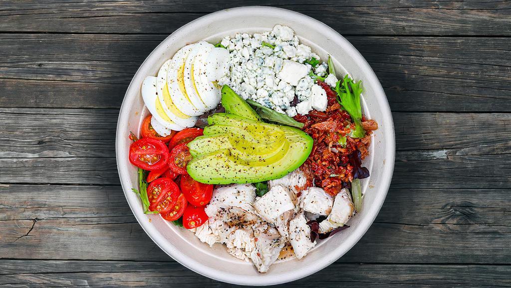 The Cobb · Grilled chicken, applewood smoked bacon, fresh avocado, crumbled blue cheese, grape tomatoes and farm fresh egg. Suggested dressing: avocado bacon ranch or buttermilk ranch. Gluten free.