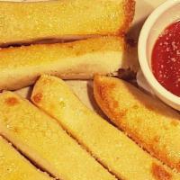 Slice Bread-Sticks · 8 Fluffly bread-sticks finished with our garlic oil and Parmesan. 
Served with our Red Gravy...