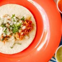 Chicken Tinga · Puebla style Shredded Chicken marinated in chipotle, adobo and tomatoes, TOPPED WITH onions/...