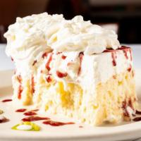 Mexican Wedding Cake · Moist, white cake soaked in sweetened creams, topped with real whipped cream (made in our ki...