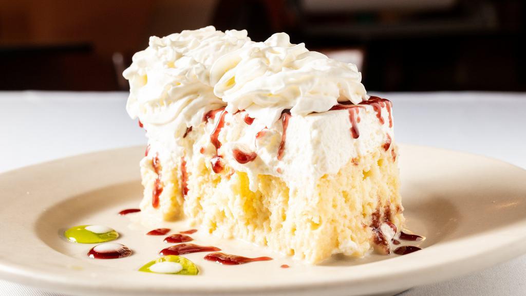 Mexican Wedding Cake · Moist, white cake soaked in sweetened creams, topped with real whipped cream (made in our kitchen) lightly drizzled in raspberry sauce and topped with a maraschino cherry. Made in house.