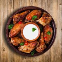 Classic Chicken Wings  · 10 chicken wings marinated in our special house spice mix and done to perfection and served ...