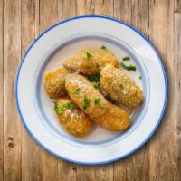Jalapeno Poppers · Crispy mild green jalapenos with cheese, served with ranch on the side.