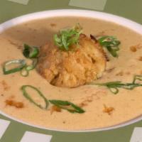 She Crab Soup · A coastal favorite, creamy, sherry-based soup topped off with lump crab meat and a mini crab...