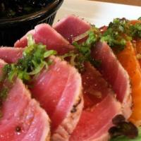 Maguro Tataki (Tuna) · Fresh Tuna Seared, 7’Spice Blend Tongarashi 
Sesame Seeds, Sonomono Vinaigrette
