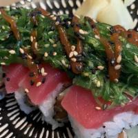 Burn Out Roll · Seared Salmon, Cream Cheese, Cucumber, Topped with Tuna, Escolar, Spicy Seaweed Salad, Tobiko
