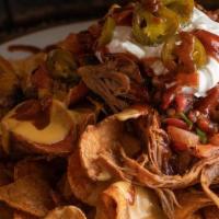 Heap' N Chips · From the farm. Doc's potato chips topped with homemade cheese sauce, BBQ sauce, pico de gall...