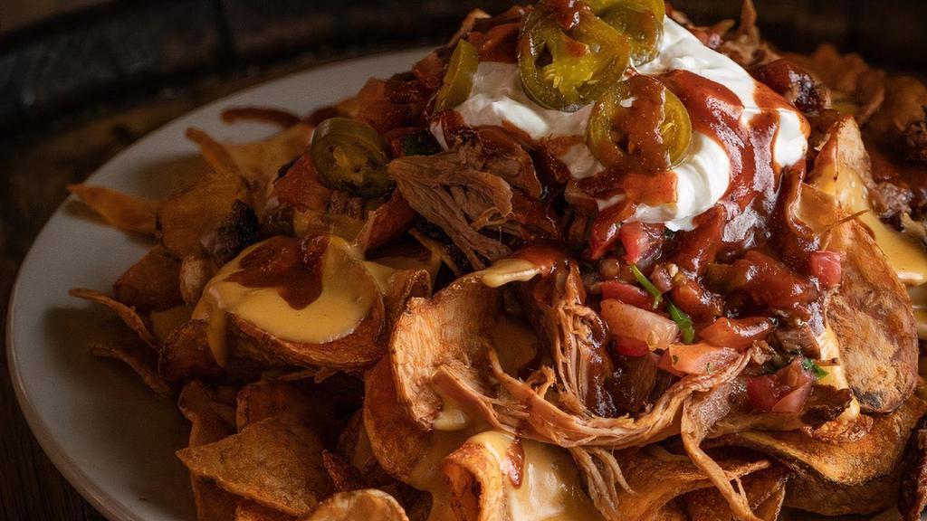 Heap' N Chips · From the farm. Doc's potato chips topped with homemade cheese sauce, BBQ sauce, pico de gallo, sour cream, melted cheddar and pickled jalapeños. topped with your choice of brisket, pulled pork, or both.