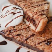 Derby Pie® · Louisville tradition, a chocolate walnut pie with bourbon-chocolate drizzle, topped with whi...