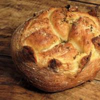 Melange Boule · Fresh thyme and rosemary blend, with a hint of garlic, shaped into our rustic boule and fini...