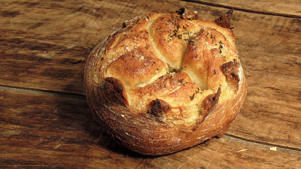 Melange Boule · Fresh thyme and rosemary blend, with a hint of garlic, shaped into our rustic boule and finished with coarse sea salt.