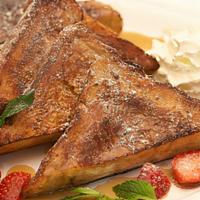 Creme Brulee French Toast · Cinnamon Brioche with amish maple syrup, strawberries and whipped cream