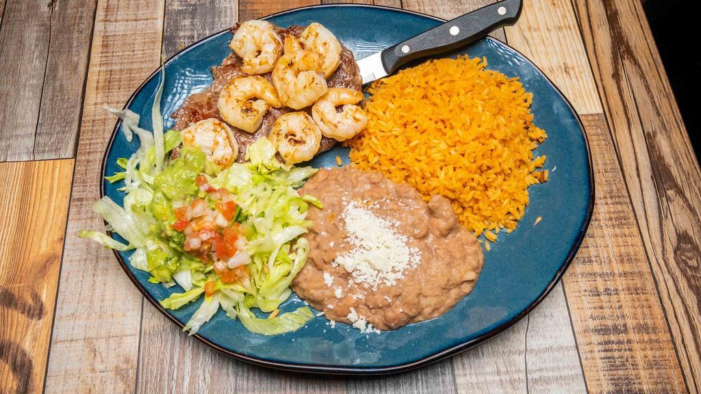 Steak & Shrimp · Ribeye steak and grilled shrimp covered with green sauce or salsa ranchera. Served with rice, beans and guacamole salad.