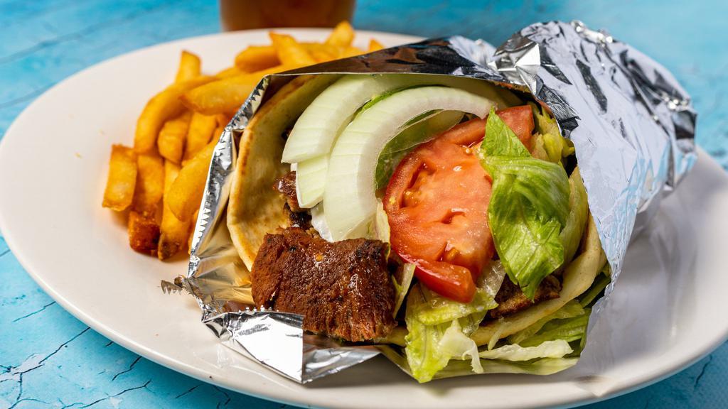 Gyro · Gyro meat pita bread topped off with tzatziki sauce, lettuce tomatoes and onion.