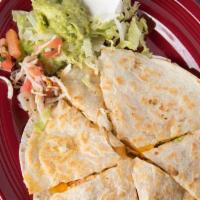Tradicional Quesadilla · Stuffed with cheddar cheese and your choice of ground beef or chicken. Topped with tomatoes,...