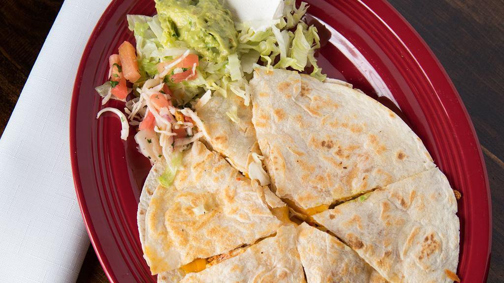  Quesadilla   · Stuffed with cheddar cheese and your choice of ground beef, or chicken. Topped with tomatoes, onions, sour cream and guacamole.