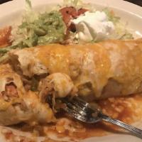 Pollo Asado Burrito · Stuffed with grilled chicken, sauteed vegetables, mushrooms, rice and black beans. Topped wi...
