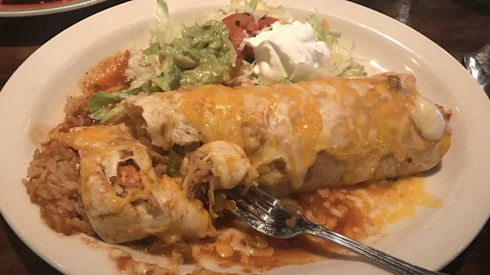 Pollo Asado Burrito · Stuffed with grilled chicken, sauteed vegetables, mushrooms, rice and black beans. Topped with tomatillo sauce and pica de gallo.