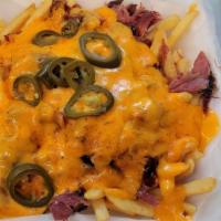 Loaded Fries · Crispy Premium Fries loaded with your choice of Pork, Turkey, or Briske. Then smothered with...