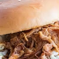 Pulled Pork Sandwich · Slow Smoked and perfectly seasoned. Then topped with our BBQ sauce, and homemade slaw