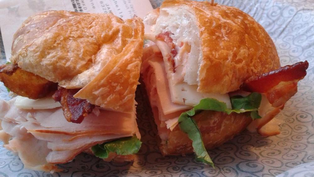 Charleston Smoked Turkey Sandwich · Havarti cheese, bacon, lettuce, tomatoes and roasted red pepper pesto mayonnaise on a sun-dried tomato baguette.