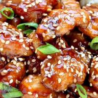 Sesame Chicken · Chunks of chicken crispy and uniquely flavored in a spicy house sauce. Served with white rice.