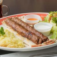 Aleppo Kebab Plate · Two Chargrilled Small Brochettes Served with Taziki Sauce and Hot Sauce