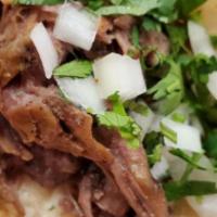 Tacos De Pescado · Tilapia with grill onions on fried tortillas.