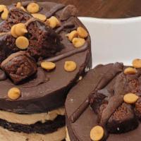 Peanut Butter Explosion · Fudge Brownie Base layered w/ Peanut Butter Mousse and Chocolate Cake.