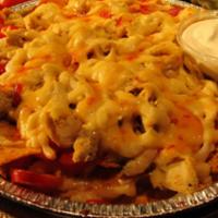 Nachos Rio Grande · Nacho chips, corn, tomatoes, jalapeños, cheese, bell peppers, onions, chili. Served with sou...