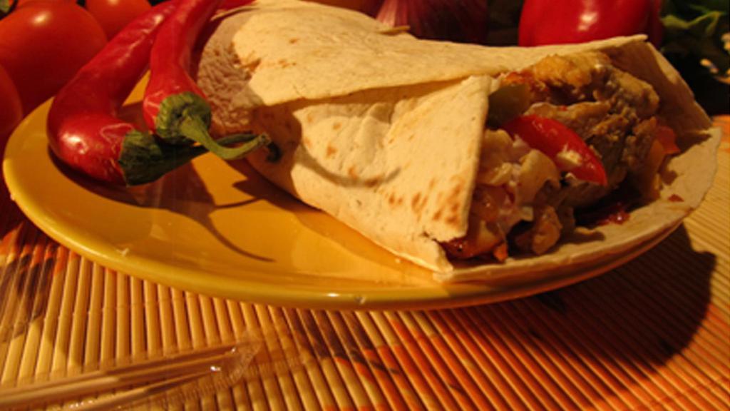 Burrito · Choose between beef, chicken, bacon, pulled pork or black beans torilla, corn, tomatoes, jalapeños, cheese, bell peppers, onions, chili. Served with sour cream and Mexican salsa.