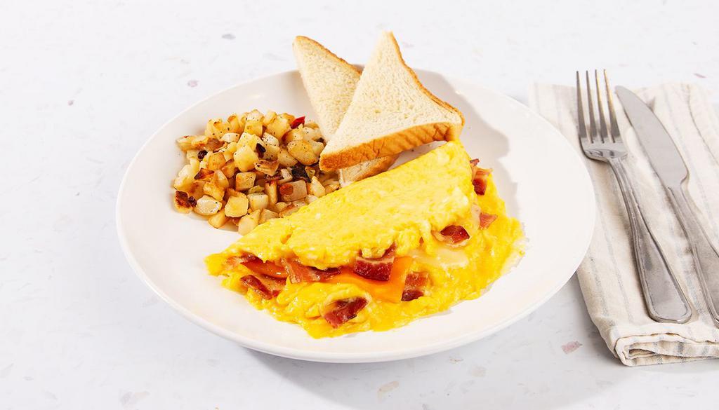 Bacon Cheese Omelette · Three eggs scrambled with cheese and crispy bacon bits. Served with home fries and toast.